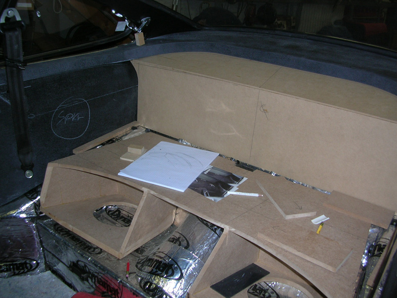 Next, a little brainstorming and some sketching brought us to a design that does not deviate to much from the traditional Porsche interior. The rear seats where deleted in favor of two 8" down firing subwoofers with some storage space on top.