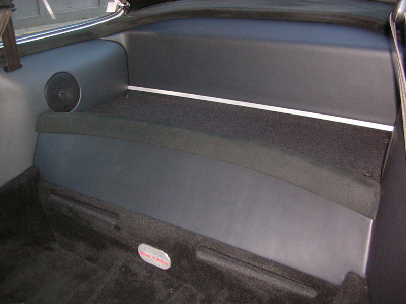 The rear deck and trim bumper where covered in suede to match the doors and dash, while the side and back panels where covered in the same vinyl as in the doors. More brushed aluminum was used to accent the back.