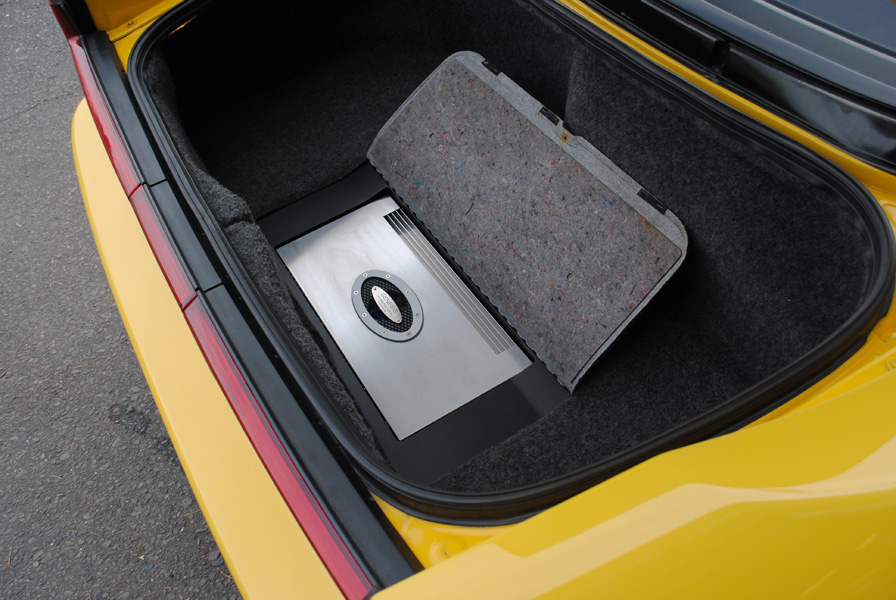 A Genesis Profile 4 Ultra amplifier was installed where the tool kit used to be in the trunk. Take a close look at the custom plastic trim piece around the amplifier.