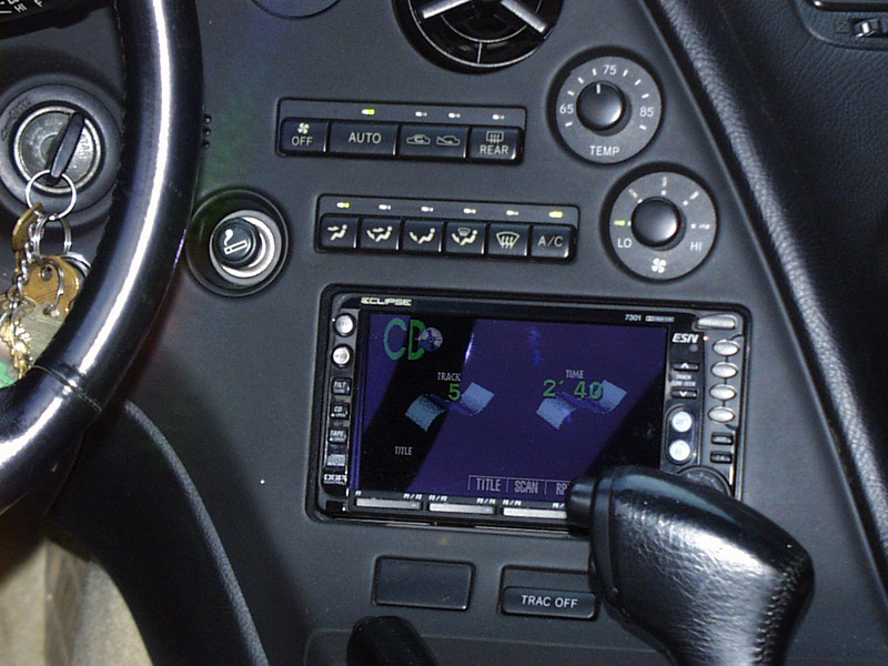 The factory double DIN opening made a nice home for the Eclipse 7301 AM/FM/Cass/CD/Video head unit. It was recessed about 5/8" and a custom trim ring was fabricated out of black acrylic. A concealed Phoenix Gold line driver was used to beef-up the pre-amp voltage.