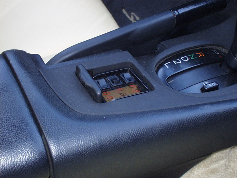 The ashtray was converted to a small control center that allows selection of the video sources and EQ settings. A custom made LCD readout displays the current status.