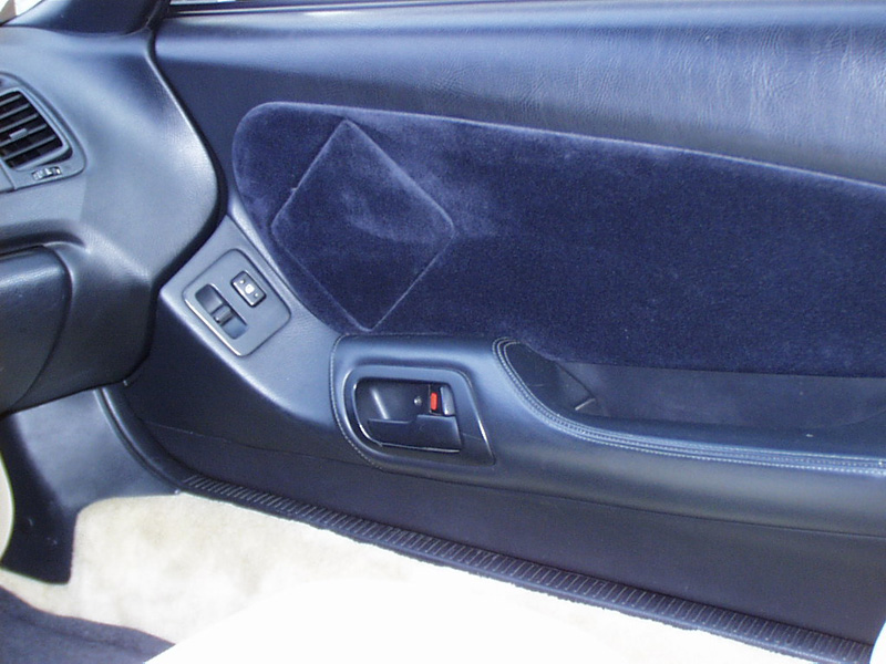 The Factory speakers were removed and a custom suede insert now accents the door. What's that rectangle?