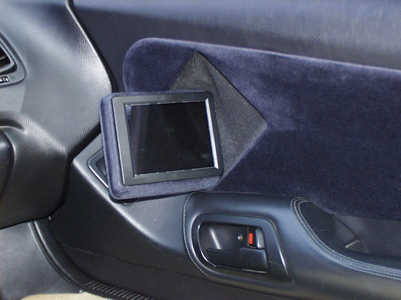 Leaving the passenger without visual entertainment would not be fair, so we utilized the factory speaker location to house an Accele 5.8 LCD monitor that motorizes in and out with the push of a button.
