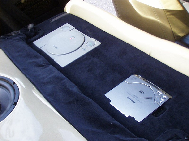 The rear seat is now motorized as well. It can be controlled either by remote control or the original release lever on top of the seat. The back is now home for a Playstation and a portable DVD player. (The best available at the time of the install).