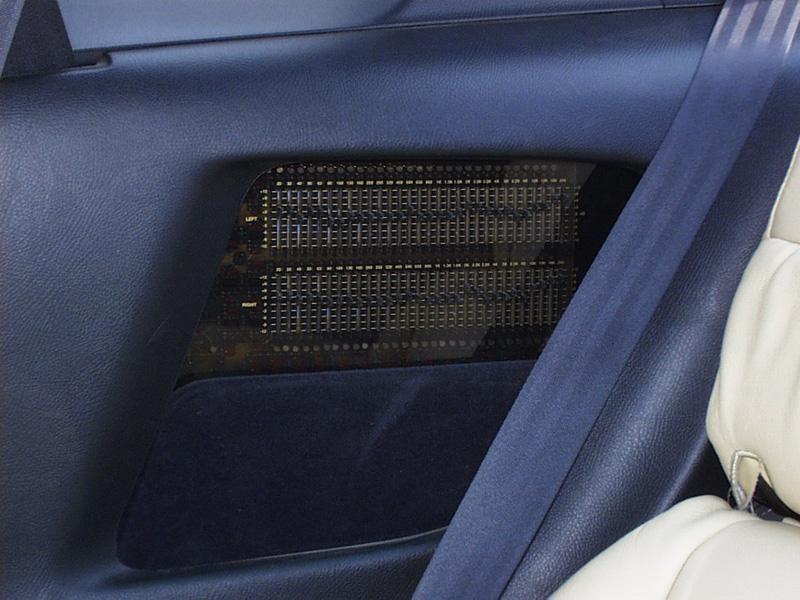 Once the cover is down, access is gained for tuning and adjustments. A 1/4" piece of tinted acrilyc was milled and then re-silcscreened to match the Phoenix Gold equipment in the back. A green neon light was installed to match the dash lights and allow for late-night tuning in the dark (usually before a competition).