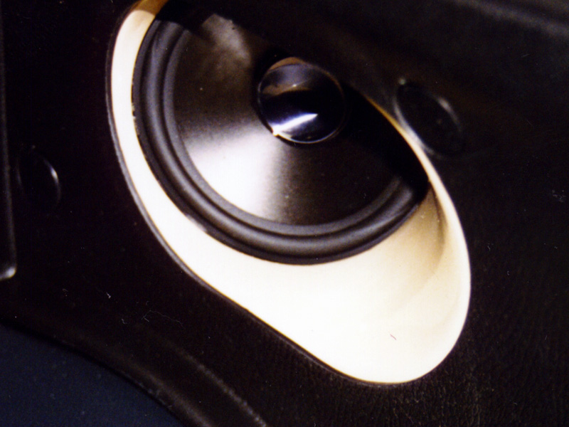 Rear-fill is exactly that, fill. No significant musical information comes from these 4" MB Quart reference-series midranges thanks to another custom built passive crossover. Two oval openings were cut into the sides of the hatch panels and a fiberglass pod aims the speakers rearward. We found this creates a perfect ambience in the car.