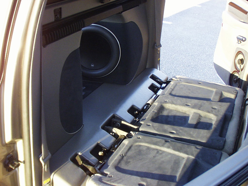 Folding the back half of the rear seat down reveals the pass through into the bed, which is now home to (4) JL Audio 13W7 13 1/2" subwoofers.