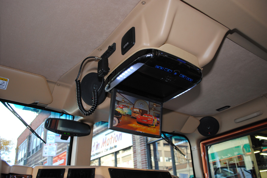 The original overhead console was modified as well. It now houses an Alpine 10.4" flip down screen and DVD player, for rear seat entertainment.