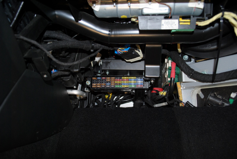 Custom brackets were fabricated in order to relocate two computers and the fuse box out of the passenger foot well and up behind the glove box. The fuses are still accessible without removing the sub.