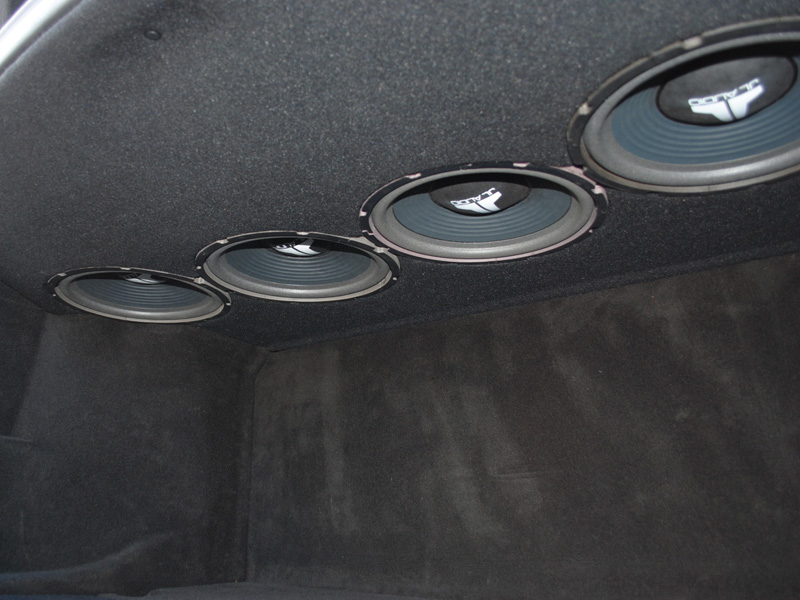 We opted for four old school JL Audio 10" free air woofers in the rear deck to retain the entire trunk and still get unbelievably accurate bass reproduction inside the cabin. They face down for better looks and to fit the magnet up higher into the rear deck between the rear strut tower brace and the rear motorized window shade, which still functions.