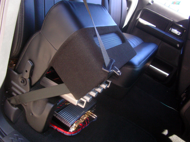You can access the amplifiers and cross-over by simply flipping up the smaller right rear passenger seat.