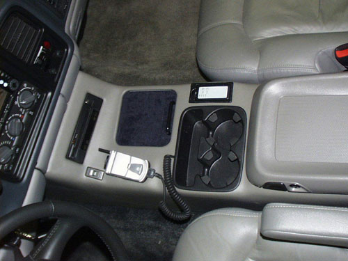 2000 Chevrolet Tahoe - An entire center console was fabricated to hold a DVD player, two CD Changers, a VCR with TV tuner, a cell phone and three A/V selectors. And the original cup holder and storage bin remain.