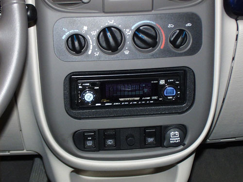 2002 Chrysler PT Cruiser - This factory radio was dissected in order to make a cover for the aftermarket radio. All of the buttons where glued back on and the back was finished in suede for a rattle free tight fit.