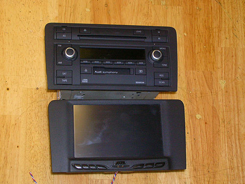 2006 Audi A3 - The top is the original Audi radio we removed, below it is the screen we installed. A custom bezel was fabricated for the screen to perfectly fit into the original dash location. Notice the perfect texture match.