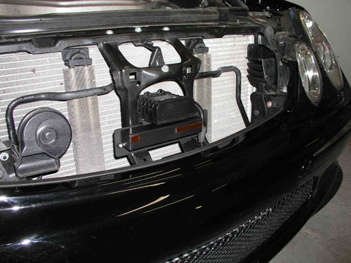2005 Mercedes E55 - Here you get a look at what you usually don't get to see. The K-40 front radar detector and Laser diffuser mounted under the hood behind the grille. It still has a straight shot of the road when the hood is shut.